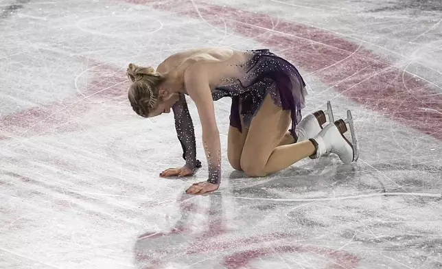 Amber Glenn, of the United States, reacts after finishing the women's free skating segment at the ISU Grand Prix Finals of Figure Skating, Saturday, Dec. 7, 2024, in Grenoble, France. (AP Photo/Laurent Cipriani)