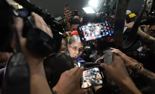 Fabio Ochoa, a former member of Cartel of Medellin, speaks to the media upon his arrival at El Dorado airport, after being deported from the United States, in Bogota, Colombia, Monday, Dec. 23, 2024. (AP Photo/Fernando Vergara)