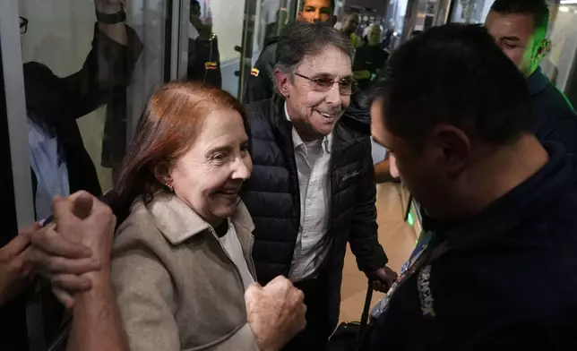 Fabio Ochoa, center, a former member of Cartel of Medellin, is welcomed by relatives upon arriving at El Dorado airport after being deported from the United States, in Bogota, Colombia, Monday, Dec. 23, 2024. (AP Photo/Fernando Vergara)