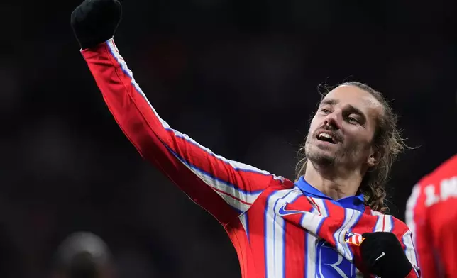 Atletico Madrid's Antoine Griezmann celebrates after scoring his side's third goal during the Champions League opening phase soccer match between Atletico Madrid and Slovan Bratislava at Riyadh Air Metropolitano stadium in Madrid, Spain, Wednesday, Dec. 11, 2024. (AP Photo/Manu Fernandez)