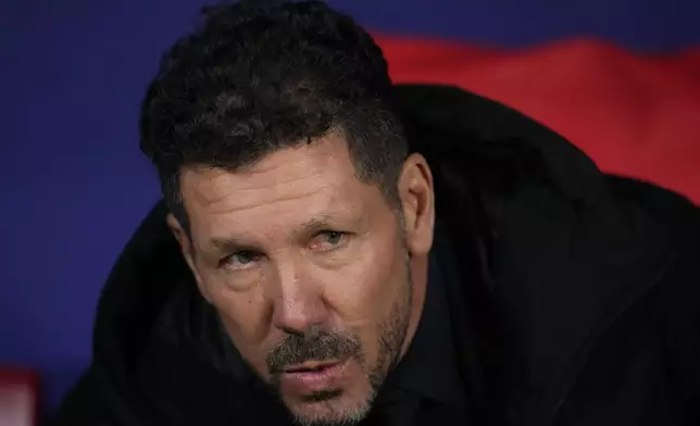 Atletico Madrid's head coach Diego Simeone watches from the team dugout before the start of the Champions League opening phase soccer match between Atletico Madrid and Slovan Bratislava at Riyadh Air Metropolitano stadium in Madrid, Spain, Wednesday, Dec. 11, 2024. (AP Photo/Manu Fernandez)