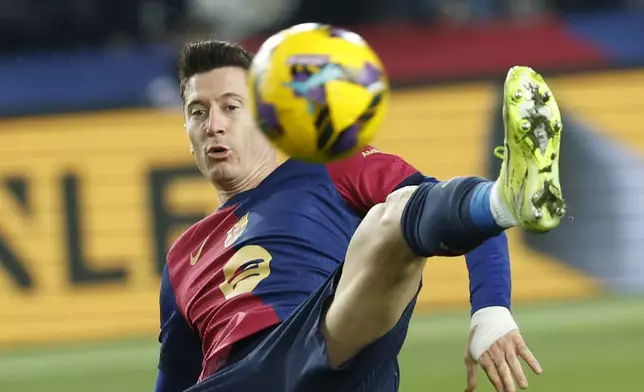 Barcelona's Robert Lewandowski challenges for the ball during the Spanish La Liga soccer match between Barcelona and Leganes at the Lluis Companys Olympic Stadium in Barcelona, Spain, Sunday, Dec. 15, 2024. (AP Photo/Joan Monfort)