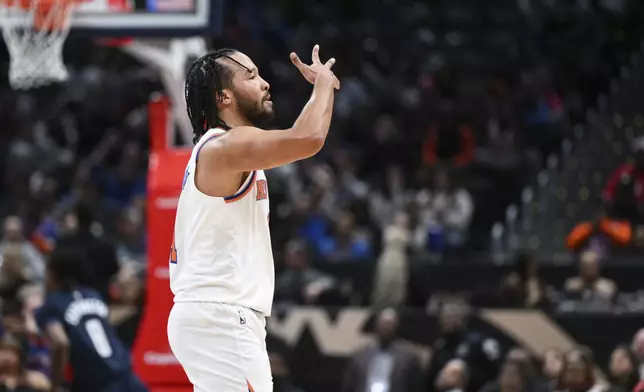 New York Knicks guard Jalen Brunson gestures after making a three-point basket during the first half of an NBA basketball game against the Washington Wizards, Saturday, Dec. 28, 2024, in Washington. (AP Photo/Terrance Williams)