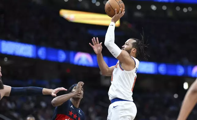 New York Knicks guard Jalen Brunson, center right, looks to shoot a jump shot during the second half of an NBA basketball game against the New York Knicks, Saturday, Dec. 28, 2024, in Washington. (AP Photo/Terrance Williams)