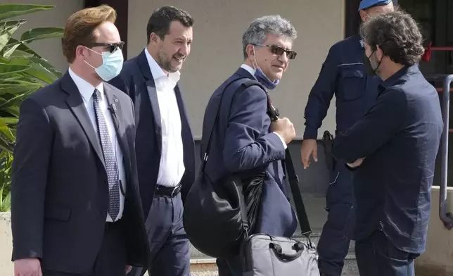 Former minister of interior Matteo Salvini, second from left, walks past Open Arms founder Oscar Camps, right, outside Palermo's court, Italy, Saturday, Oct. 23, 2021. (AP Photo/Gregorio Borgia, File)