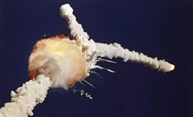 The space shuttle Challenger is destroyed shortly after lifting off, Tuesday, Jan. 28, 1986, at the Kennedy Space Center in Florida. The crew of seven, including NASA's first teacher in space Christa McAuliffe, died in the explosion. (AP Photo/Bruce Weaver, File)