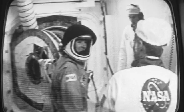 Christa McAuliffe, NASA's first teacher in space, smiles after she was suited up for her space flight, Jan. 27, 1986, at the Kennedy Space Center in Florida. (NASA via AP, File)