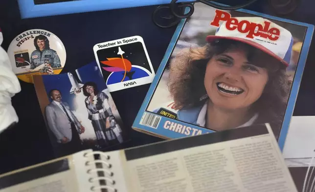 A selection of memorabilia featuring Christa McAuliffe, NASA's first teacher in space, is displayed at the McAuliffe-Shepard Discovery Center, Monday, Dec. 16, 2024, in Concord, N.H. (AP Photo/Charles Krupa)