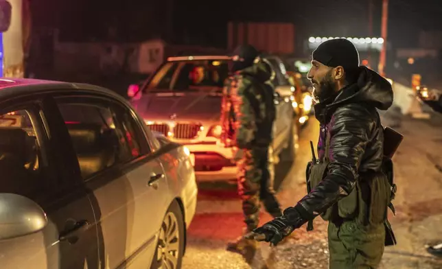 Members of the security forces of the newly formed Syrian government stand guard at a security checkpoint on the Syrian border with Lebanon, Friday, Dec. 27, 2024 (AP Photo/Mosa'ab Elshamy)