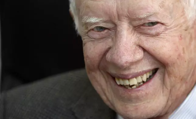 FILE - Former U.S. President Jimmy Carter smiles during a meeting with Sudanese officials at the national elections commission in Khartoum, Sudan, April 9, 2010. Carter was in the country to help monitor the elections. (AP Photo/Amr Nabil, File)