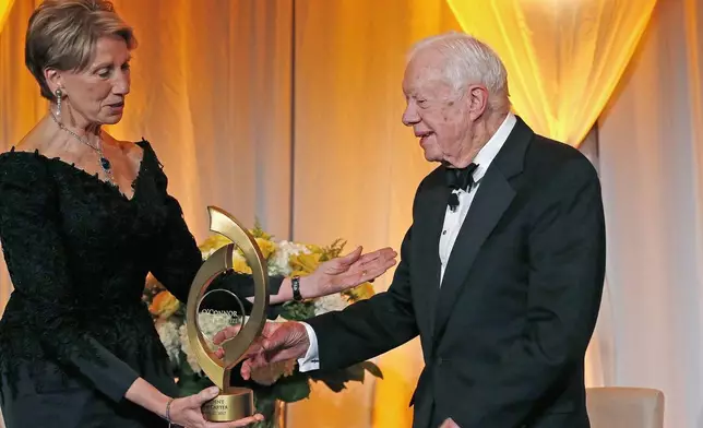 FILE - Former President Jimmy Carter accepts the O'Connor Justice Prize from former U.S. Ambassador to Finland Barbara Barrett at The Sandra Day O'Connor College of Law at Arizona State University in Phoenix, Jan. 27, 2017. The prize recognizes people who have made extraordinary contributions to advancing the rule of law, justice and human rights. (AP Photo/Ross D. Franklin, File)