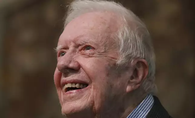 FILE - Former President Jimmy Carter smiles as he returns to Maranatha Baptist Church in Plains, Ga., to teach Sunday school, June 9, 2019, less than a month after falling and breaking his hip. (Curtis Compton/Atlanta Journal-Constitution via AP, File)