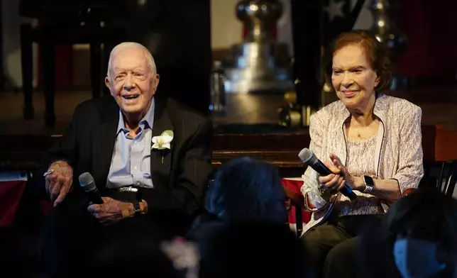 FILE - Former President Jimmy Carter, left, and his wife, former first lady Rosalynn Carter, sit together during a reception to celebrate their 75th anniversary, July 10, 2021, in Plains, Ga. (AP Photo/John Bazemore, Pool, File)