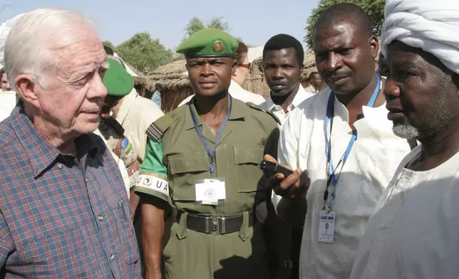 FILE - Former U.S. President Jimmy Carter meets representatives of ethnic African refugees in Kabkabiya town in Darfur, Oct. 3, 2007. The visit by "The Elders," which is headed by Carter and Nobel Peace laureate Desmond Tutu, is largely a symbolic move by a host of respected figures to push all sides to make peace in Darfur. (AP Photo/Alfred de Montesquiou, File)