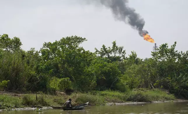 FILE - A man paddles his canoe in the Niger Delta near the village of Ogboinbiri, Nigeria, Dec. 11, 2024. (AP Photo/Sunday Alamba, File)