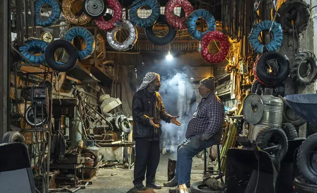 Wokers at a tyre shop wait for customers in Douma, on the outskirts of Damascus, Syria, Sunday, Dec. 29, 2024 (AP Photo/Mosa'ab Elshamy)