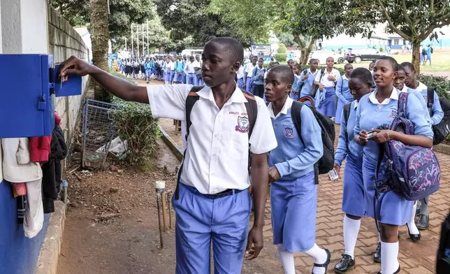 Students sign out for classes at Wampewo Ntakke Secondary School in Kawempe tula village, Kampala, Uganda on Nov. 4, 2024. (AP Photo/Hajarah Nalwadda)