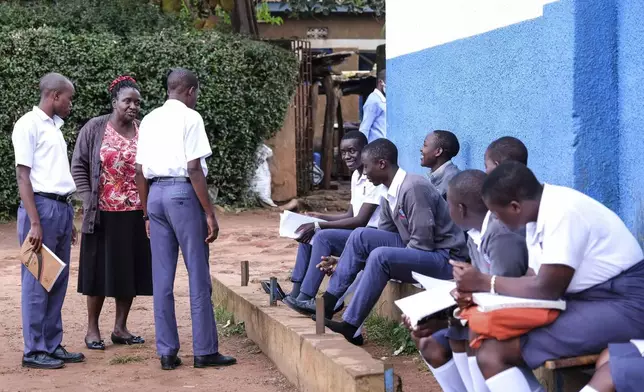 Joanita Seguya, second left, interacts with students at Wampewo Ntakke Secondary School in Kampala, Uganda on Nov. 4, 2024. (AP Photo/Hajarah Nalwadda)