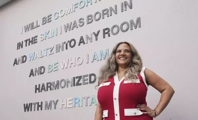 Renee O'Connor near a mural at Miami Norland Senior High School, Thursday, Dec. 19, 2024, in Miami Gardens, Fla. (AP Photo/Marta Lavandier)