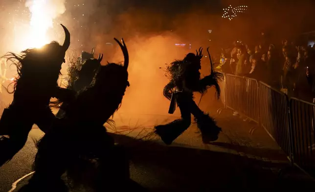 Participants wearing traditional Krampus costumes perform during a Krampus run in Hollabrunn, Austria, Saturday, Nov. 30, 2024. (AP Photo/Denes Erdos)