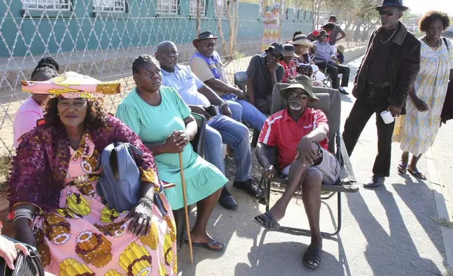 Namibians queue to cast their votes in a presidential election in Windhoek, Namibia Wednesday, Nov. 27, 2024. (AP Photo/Dirk Heinrich)