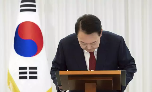 In this photo released by South Korean President Office via Yonhap, South Korean President Yoon Suk Yeol bows while delivering a speech at the presidential residence in Seoul, South Korea, after South Korea’s parliament voted to impeach Yoon Saturday, Dec. 14, 2024. (South Korean Presidential Office/Yonhap via AP)