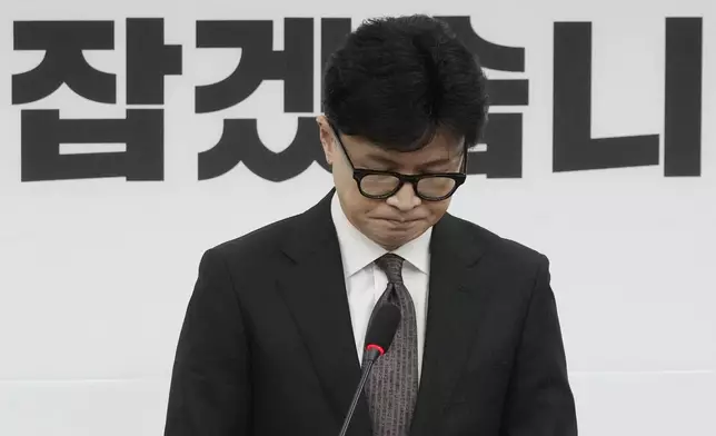 South Korea's ruling People Power Party leader Han Dong-hun reacts during a news conference to announce his resignation after President Yoon Suk Yeol's parliamentary impeachment, at the National Assembly in Seoul, South Korea, Monday, Dec. 16, 2024. (AP Photo/Ahn Young-joon)