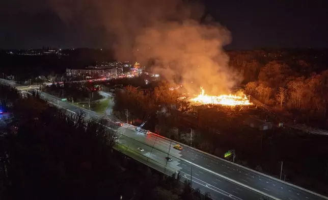 The southbound lanes of I-83 are shut down as a massive fire burns nearby at the Camp Small city wood recycling facility in Baltimore, on Thursday, Dec. 5, 2024. (Jerry Jackson/The Baltimore Banner via AP)