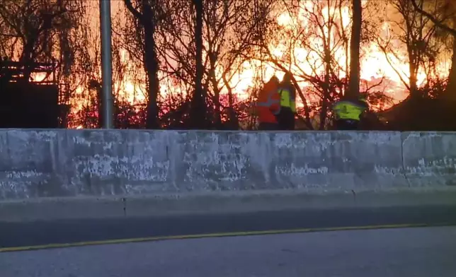 Firefighters are on the scene of a brushfire at a Baltimore wood recycling yard late Thursday, Dec. 5, 2024. (WMAR via AP)