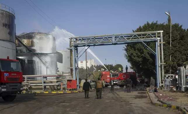 Firefighters work at the scene of an Israeli airstrike on the Haziz power station in southern Sanaa, Yemen, Thursday, Dec. 19, 2024. A series of intense Israeli airstrikes rocked Yemen's rebel-held capital and a port city early Thursday, killing at least nine people, according to officials. This attack came shortly after a Houthi missile targeted central Israel. (AP Photo/Osamah Abdulrahman)