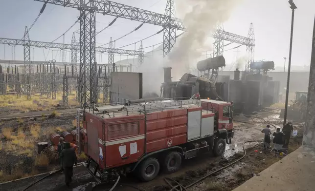 Firefighters work at the scene of an Israeli airstrike on the Haziz power station in southern Sanaa, Yemen, Thursday, Dec. 19, 2024. A series of intense Israeli airstrikes rocked Yemen's rebel-held capital and a port city early Thursday, killing at least nine people, according to officials. This attack came shortly after a Houthi missile targeted central Israel. (AP Photo/Osamah Abdulrahman)