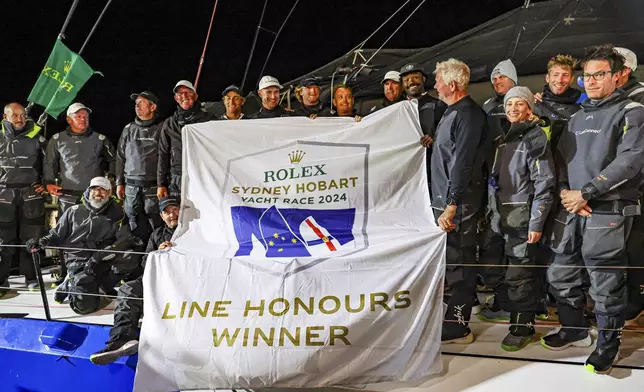 Crew of Law Connect pose for a photo after winning line honours in the Sydney to Hobart yacht race in Hobart, Australia, Saturday, Dec. 28, 2024. (Salty Dingo via AP)