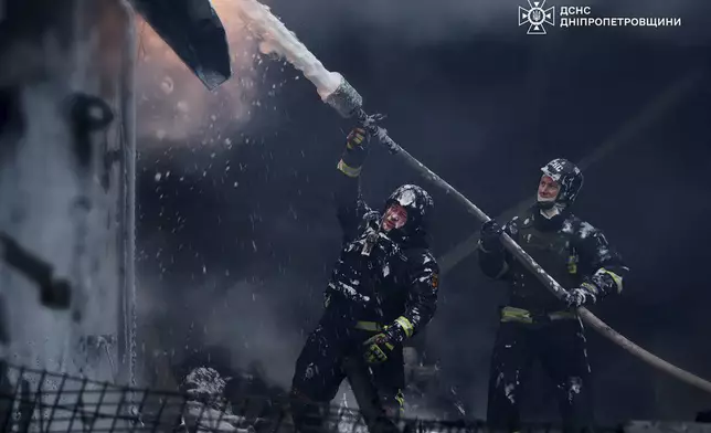 In this image provided by the Ukrainian Emergency Service, firefighters put out a fire following a Russian missile attack on the country's energy system in Dnipropetrovsk region, Ukraine, Wednesday, Dec. 25, 2024. (Ukrainian Emergency Service via AP)