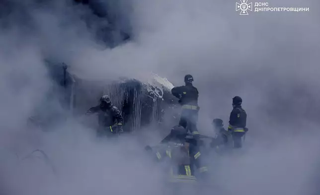 In this image provided by the Ukrainian Emergency Service, firefighters put out the fire following a Russian missile attack on the country's energy system in Dnipropetrovsk region, Ukraine, Wednesday, Dec. 25, 2024. (Ukrainian Emergency Service via AP)