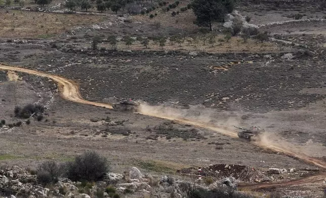 Israeli tanks cross the security fence moving towards the so-called Alpha Line that separates the Israeli-annexed Golan Heights from Syria, in the town of Majdal Shams, Wednesday, Dec. 11, 2024. (AP Photo/Matias Delacroix)