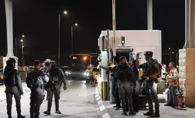 Israeli security forces work at the scene of a shooting attack on a bus near the West Bank town of Beit Jala, early Thursday, Dec. 12, 2024. (AP Photo/Mahmoud Illean)