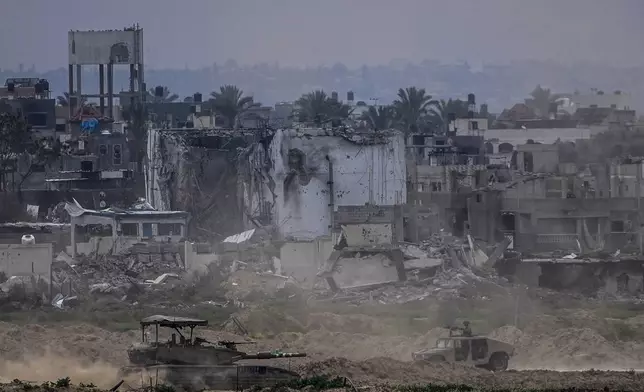 FILE - Israeli soldiers operate inside the Gaza Strip, as seen from southern Israel, Feb. 13, 2024. (AP Photo/Ariel Schalit, File)