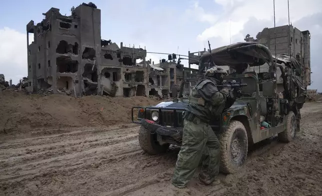 FILE - An Israeli soldier stands guard in Khan Younis, Jan. 27, 2024. (AP Photo/Sam McNeil, File)