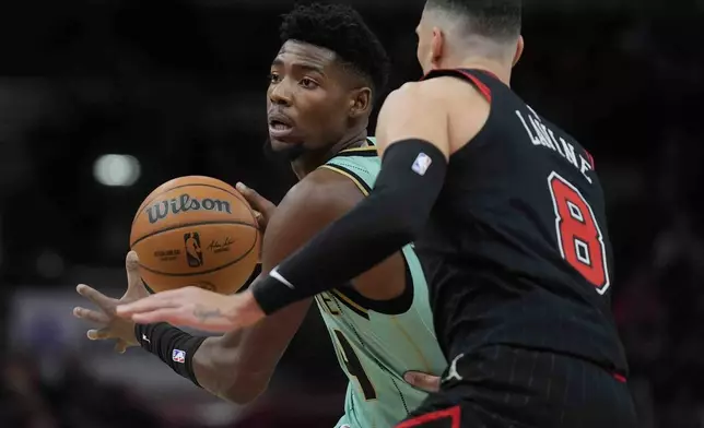 Chicago Bulls guard Zach LaVine, right, guards against Charlotte Hornets forward Brandon Miller, left, during the first half of an NBA basketball game Friday, Dec. 13, 2024, in Chicago. (AP Photo/Erin Hooley)