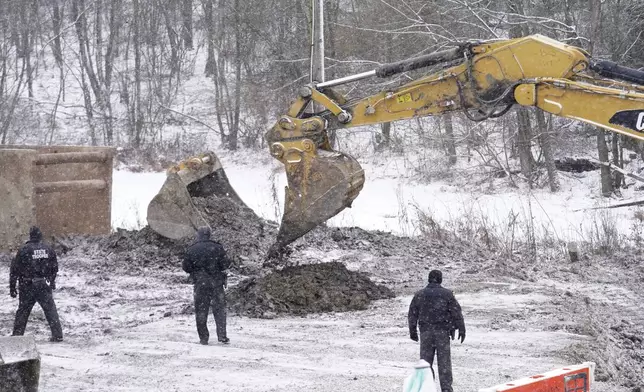 Rescue workers continue to search, Thursday, Dec. 5, 2024, for Elizabeth Pollard, who is believed to have disappeared in a sinkhole while looking for her cat, in Marguerite, Pa. (AP Photo/Matt Freed)