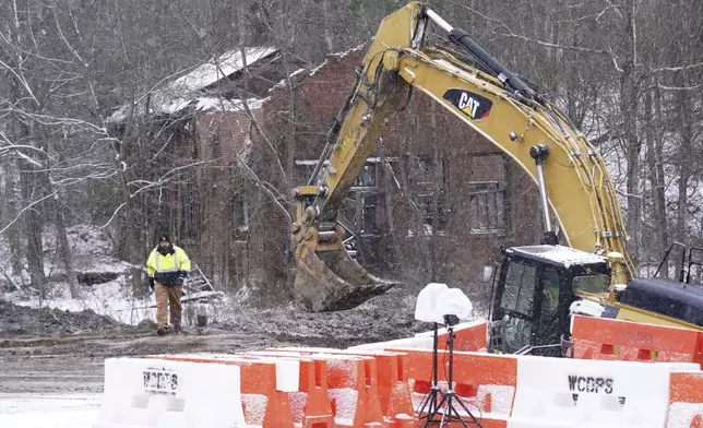 Rescue workers continue to search, Thursday, Dec. 5, 2024, for Elizabeth Pollard, who is believed to have disappeared in a sinkhole while looking for her cat, in Marguerite, Pa. (AP Photo/Matt Freed)