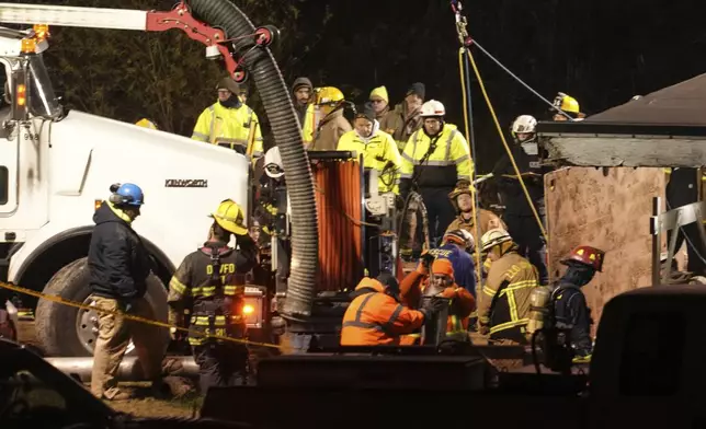 Rescue workers search in a sinkhole for Elizabeth Pollard, who disappeared while looking for her cat, in Marguerite, Pa., Tuesday, Dec. 3, 2024. (AP Photo/Gene J. Puskar)