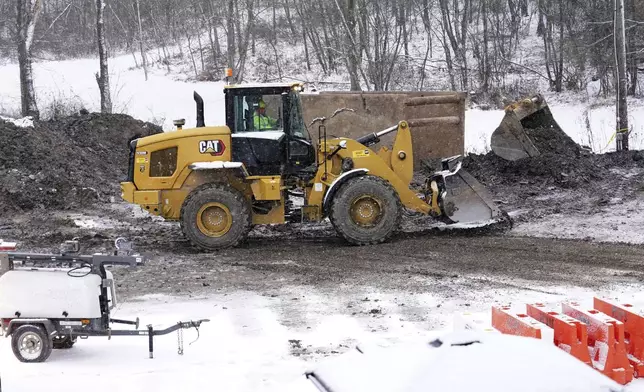 Rescue workers continue to search, Thursday, Dec. 5, 2024, for Elizabeth Pollard, who is believed to have disappeared in a sinkhole while looking for her cat, in Marguerite, Pa. (AP Photo/Matt Freed)