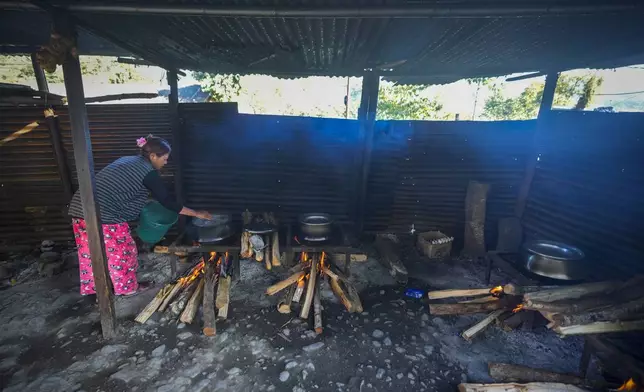 A Kuki tribal cooks food in a relief camp in Kangpokpi, Manipur, Sunday, Dec. 15, 2024. (AP Photo/Anupam Nath)