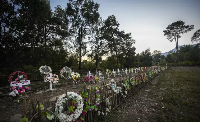 Flowers are placed at a burial ground of Kuki victims died during Kuki and Meitei clashes in Kangpokpi, Manipur, Sunday, Dec. 15, 2024. (AP Photo/Anupam Nath)