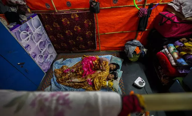 A Kuki tribal woman and her daughter rest in a relief camp in Kangpokpi, Manipur, Sunday, Dec. 15, 2024. (AP Photo/Anupam Nath)