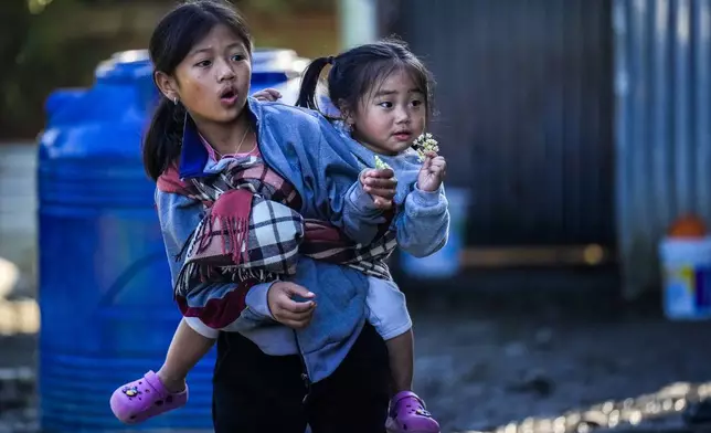 Kuki tribal children play outside their relief camp in Kangpokpi, Manipur, Sunday, Dec. 15, 2024. (AP Photo/Anupam Nath)