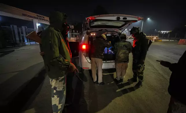 Security personnel check vehicles in Imphal, Manipur, Sunday, Dec. 15, 2024. (AP Photo/Anupam Nath)