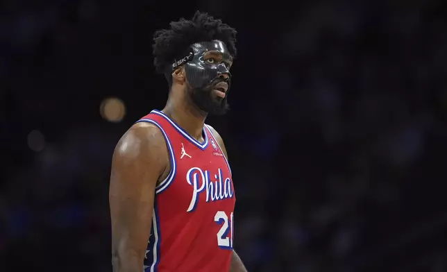 Philadelphia 76ers' Joel Embiid walks the court during the first half of an NBA basketball game against the Charlotte Hornets, Friday, Dec. 20, 2024, in Philadelphia. (AP Photo/Matt Slocum)