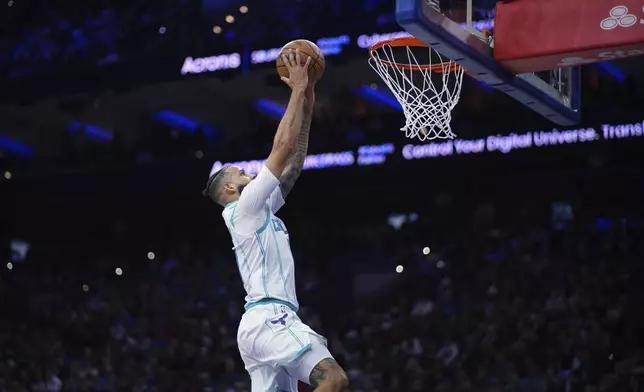 Charlotte Hornets' Cody Martin goes up for a dunk during the first half of an NBA basketball game against the Philadelphia 76ers, Friday, Dec. 20, 2024, in Philadelphia. (AP Photo/Matt Slocum)